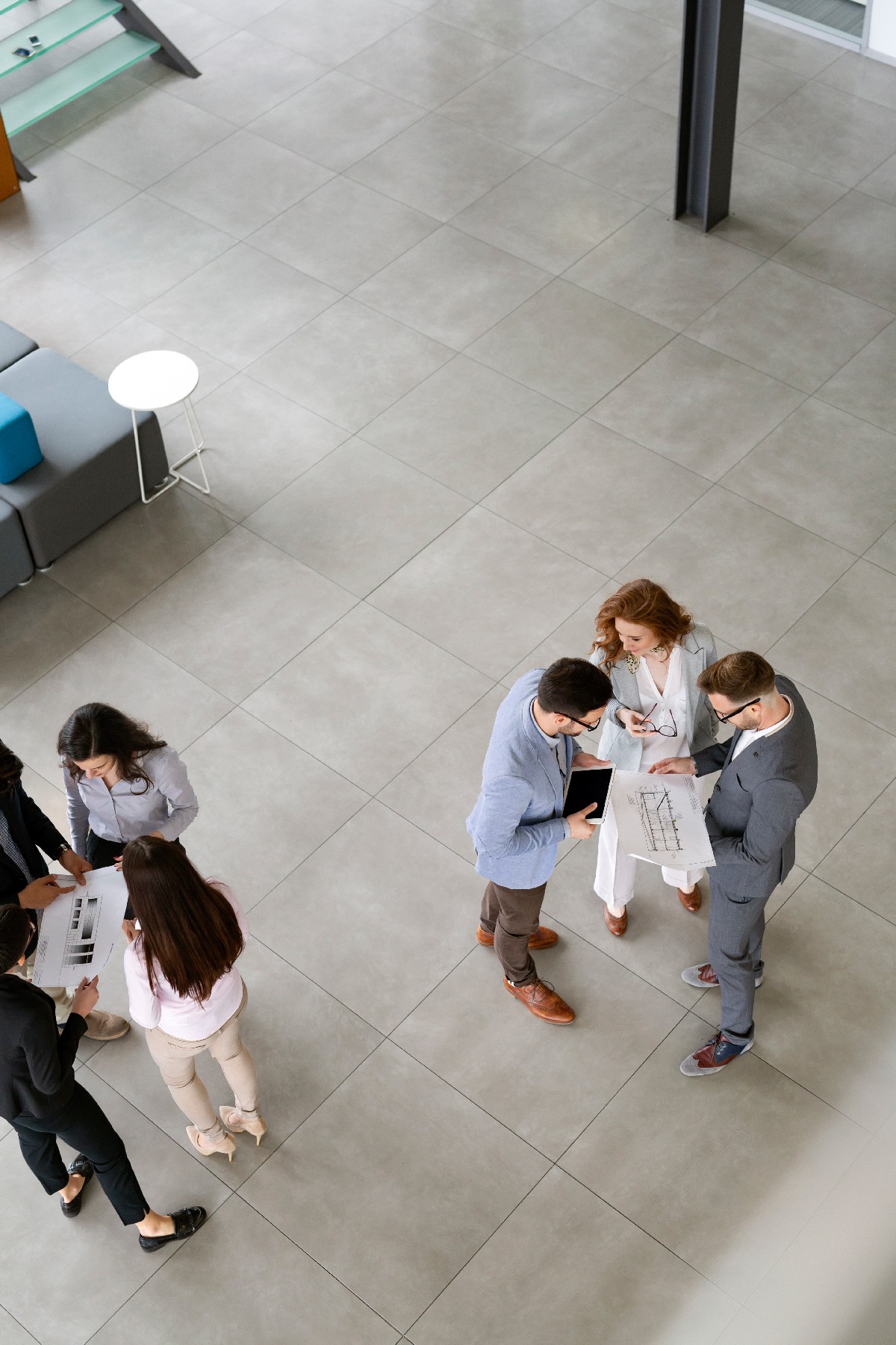 Group Of Lawyers Discussing Contract Together In Office